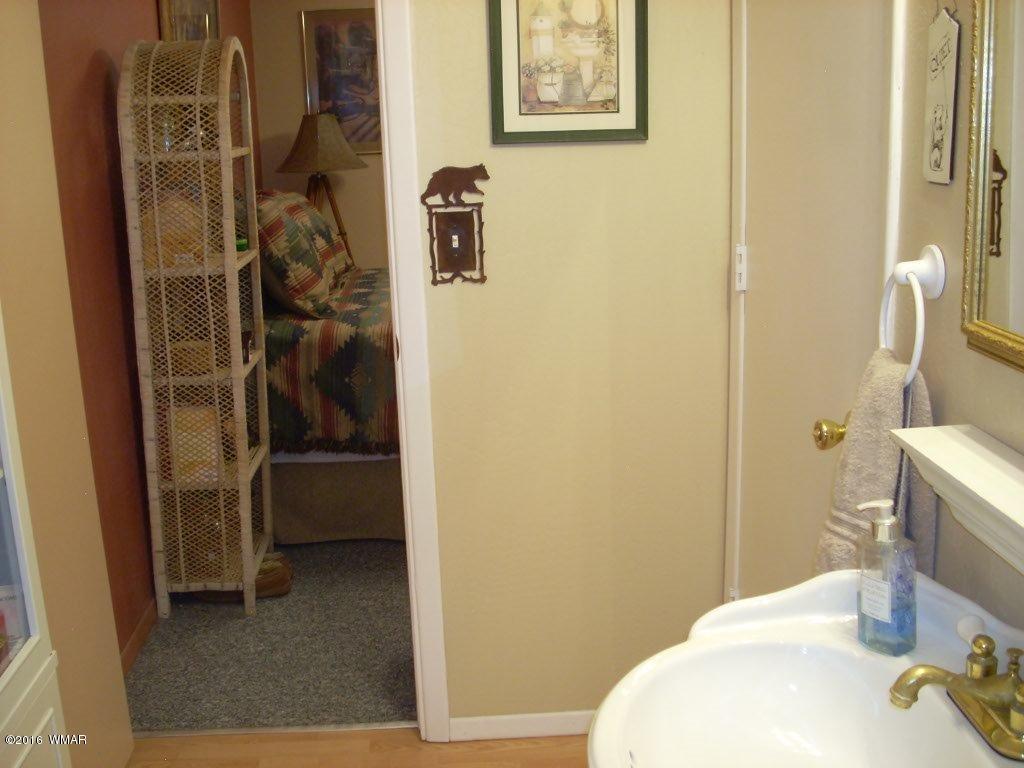 2101 Chevelon Road Overgaard, AZ 85933 - Photo 27 of 45 a bathroom with a sink and a mirror