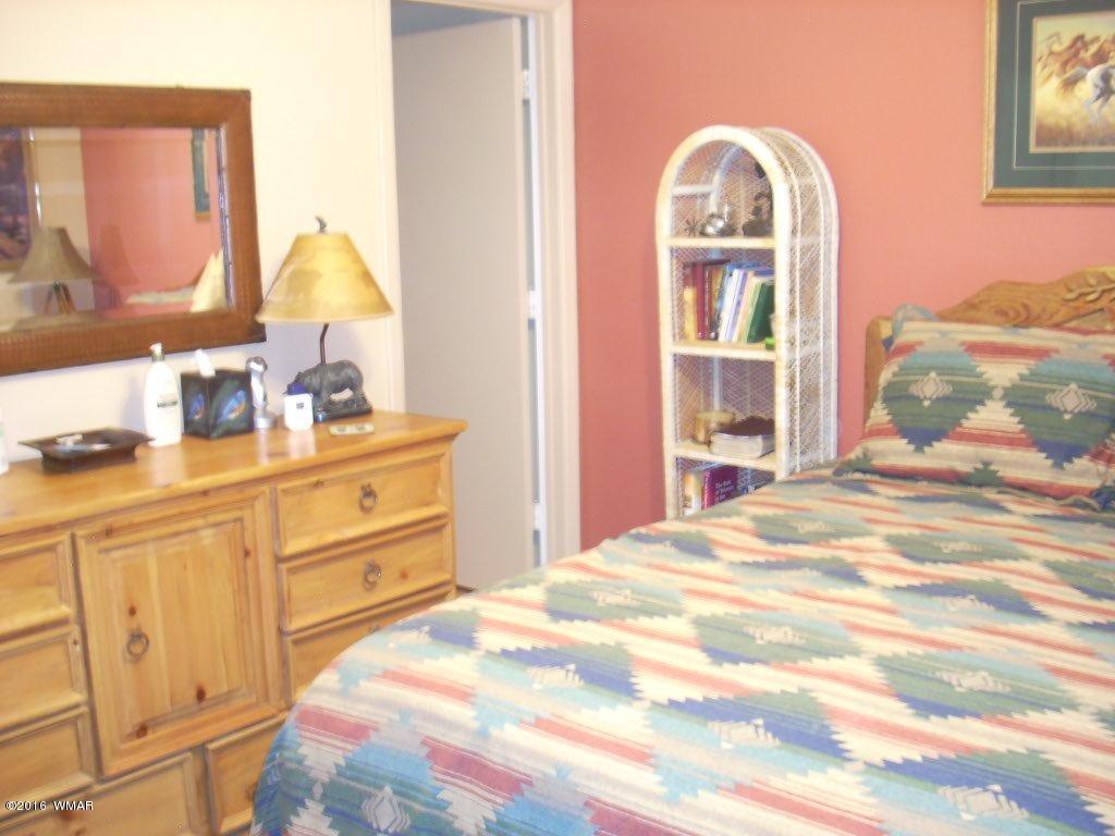 2101 Chevelon Road Overgaard, AZ 85933 - Photo 28 of 45 a bedroom with a bed and a dresser