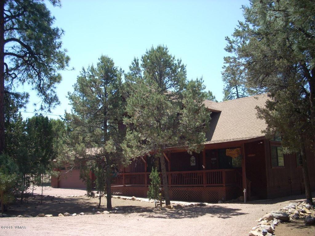 2101 Chevelon Road Overgaard, AZ 85933 - Photo 3 of 45 a front view of a house with a yard