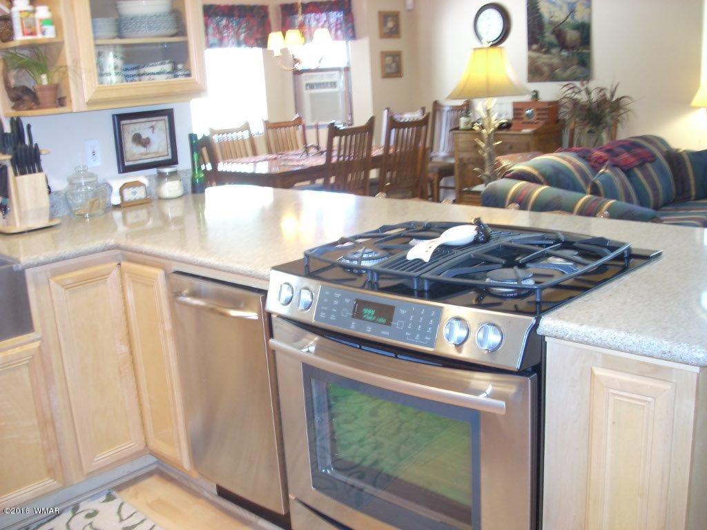 2101 Chevelon Road Overgaard, AZ 85933 - Photo 45 of 45 a kitchen with a stove a sink and a cabinets