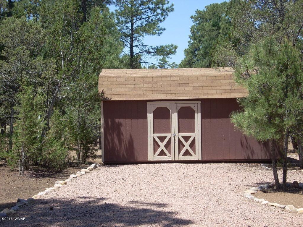 2101 Chevelon Road Overgaard, AZ 85933 - Photo 7 of 45 a front view of a house with a yard and garage