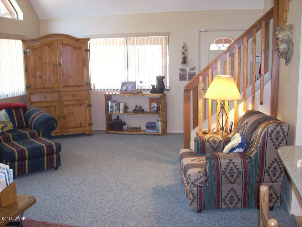2101 Chevelon Road Overgaard, AZ 85933 - Photo 9 of 45 a living room with furniture and a chandelier