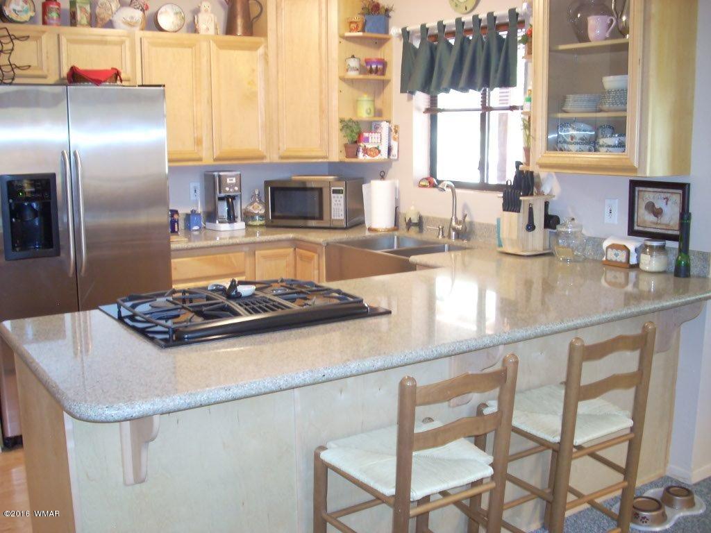 2101 Chevelon Road Overgaard, AZ 85933 - Photo 10 of 45 a kitchen with a stove a sink and a refrigerator