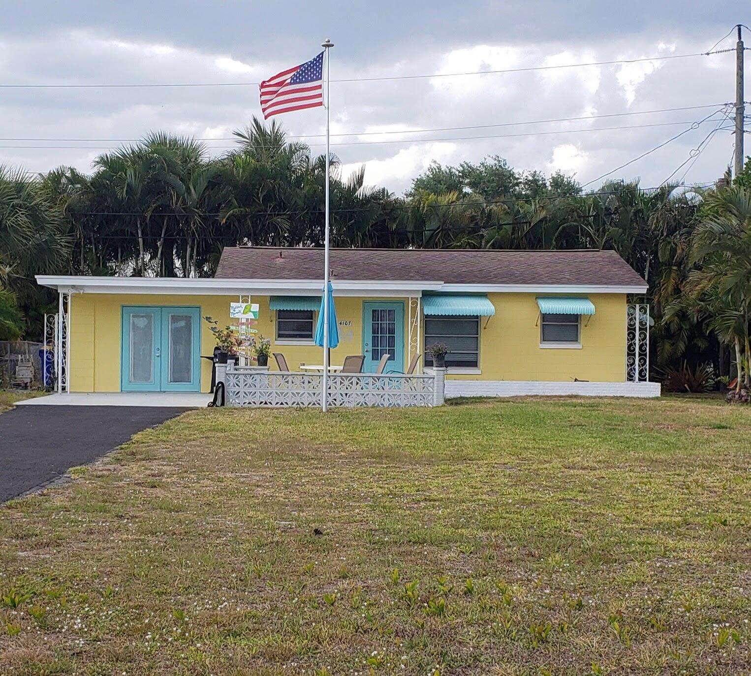 4107 Southeast Barcelona Street Stuart, FL 34997 - Photo 2 of 19 a front view of a house with garden