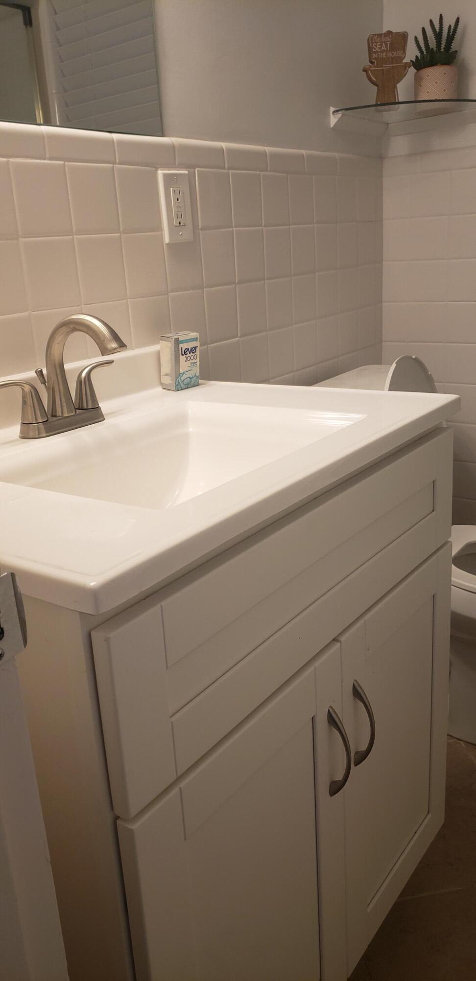4107 Southeast Barcelona Street Stuart, FL 34997 - Photo 3 of 19 a bathroom with a sink and vanity