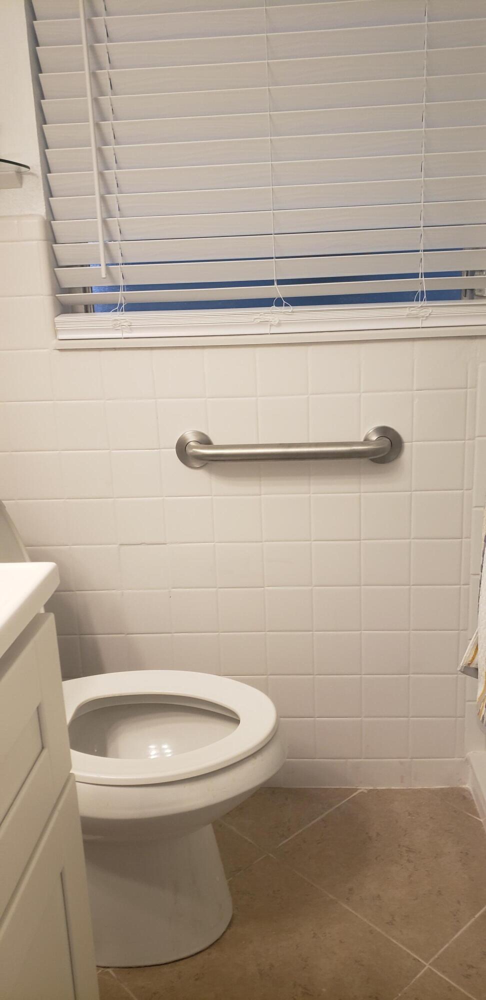 4107 Southeast Barcelona Street Stuart, FL 34997 - Photo 6 of 19 a white toilet sitting next to a shower