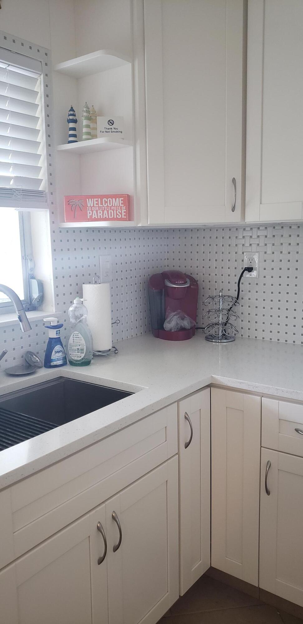 4107 Southeast Barcelona Street Stuart, FL 34997 - Photo 7 of 19 a kitchen with a sink dishwasher and cabinets