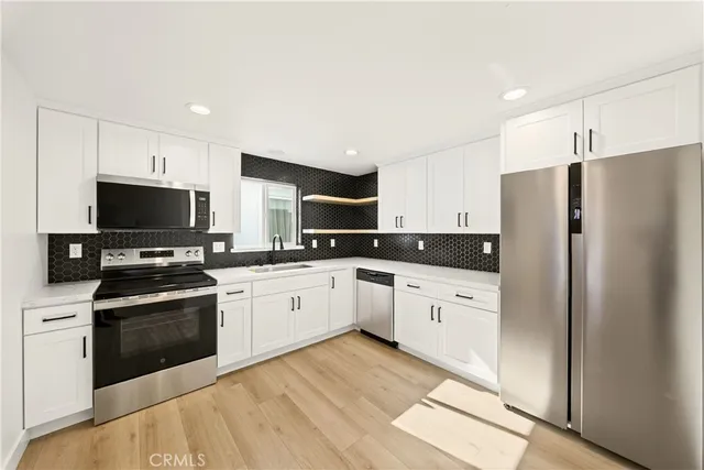 a kitchen with a sink stainless steel appliances and cabinets