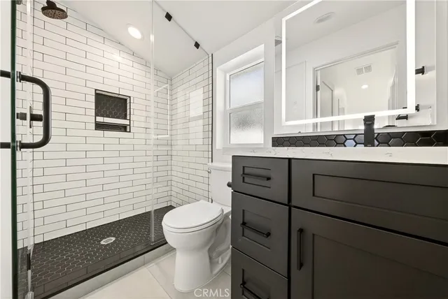 a bathroom with a sink a toilet and mirror