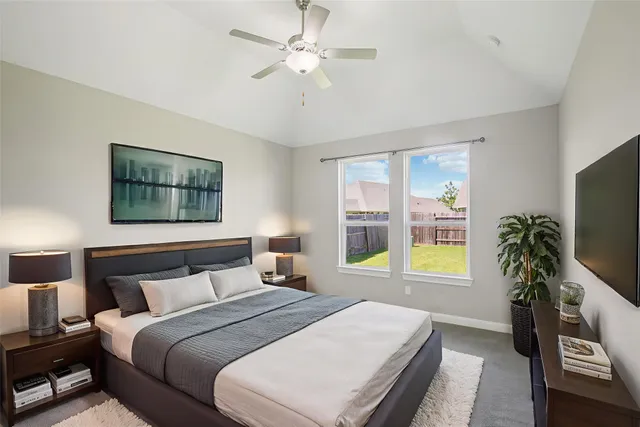 a bedroom with a large bed and a flat screen tv