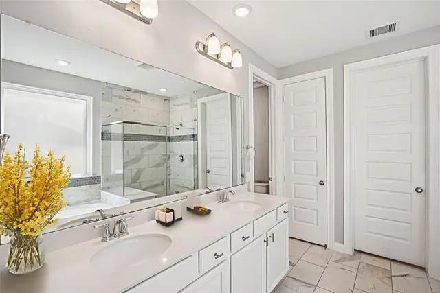 a bathroom with a double vanity sink and a mirror