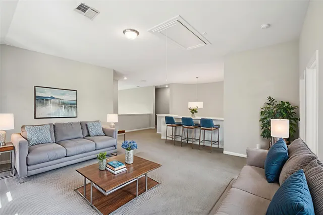 a living room with furniture potted plant and a window