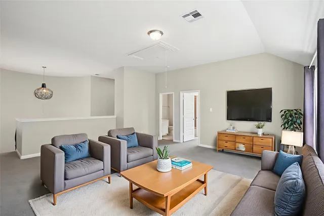 a bedroom with a large bed and a potted plant