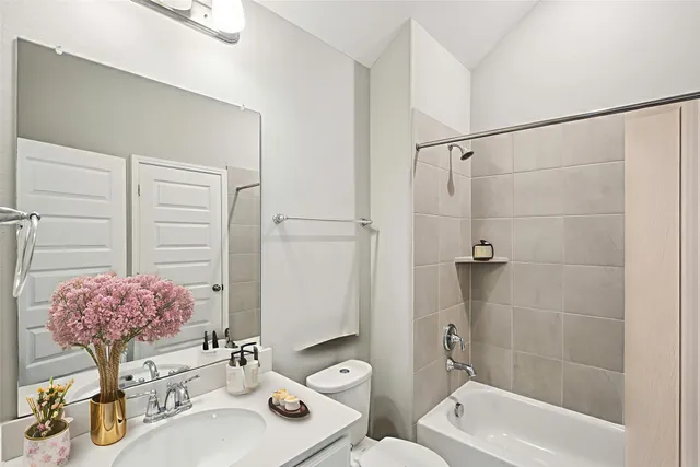 a bathroom with a toilet sink shower and mirror