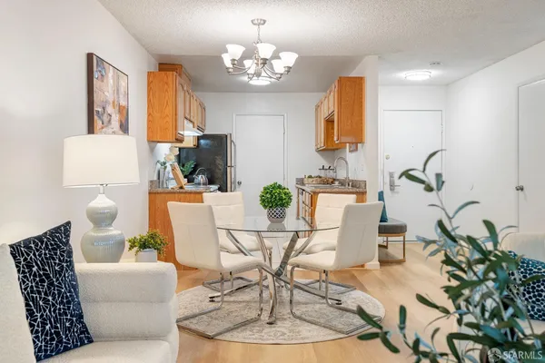 a living room with patio furniture and a chandelier