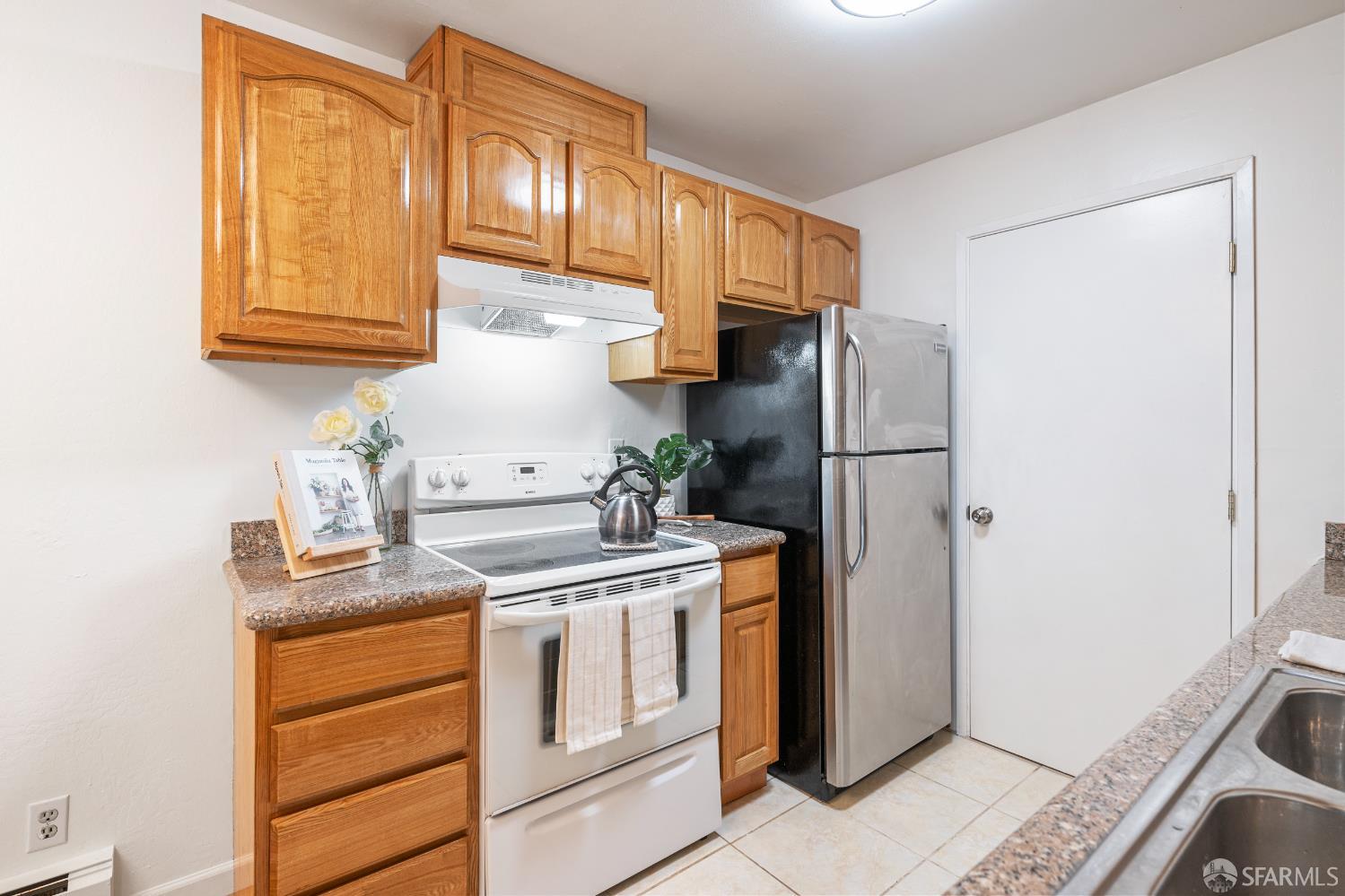 1327 Webster Street, Unit B210 Alameda, CA 94501 - Photo 15 of 55 a kitchen with a refrigerator sink and cabinets