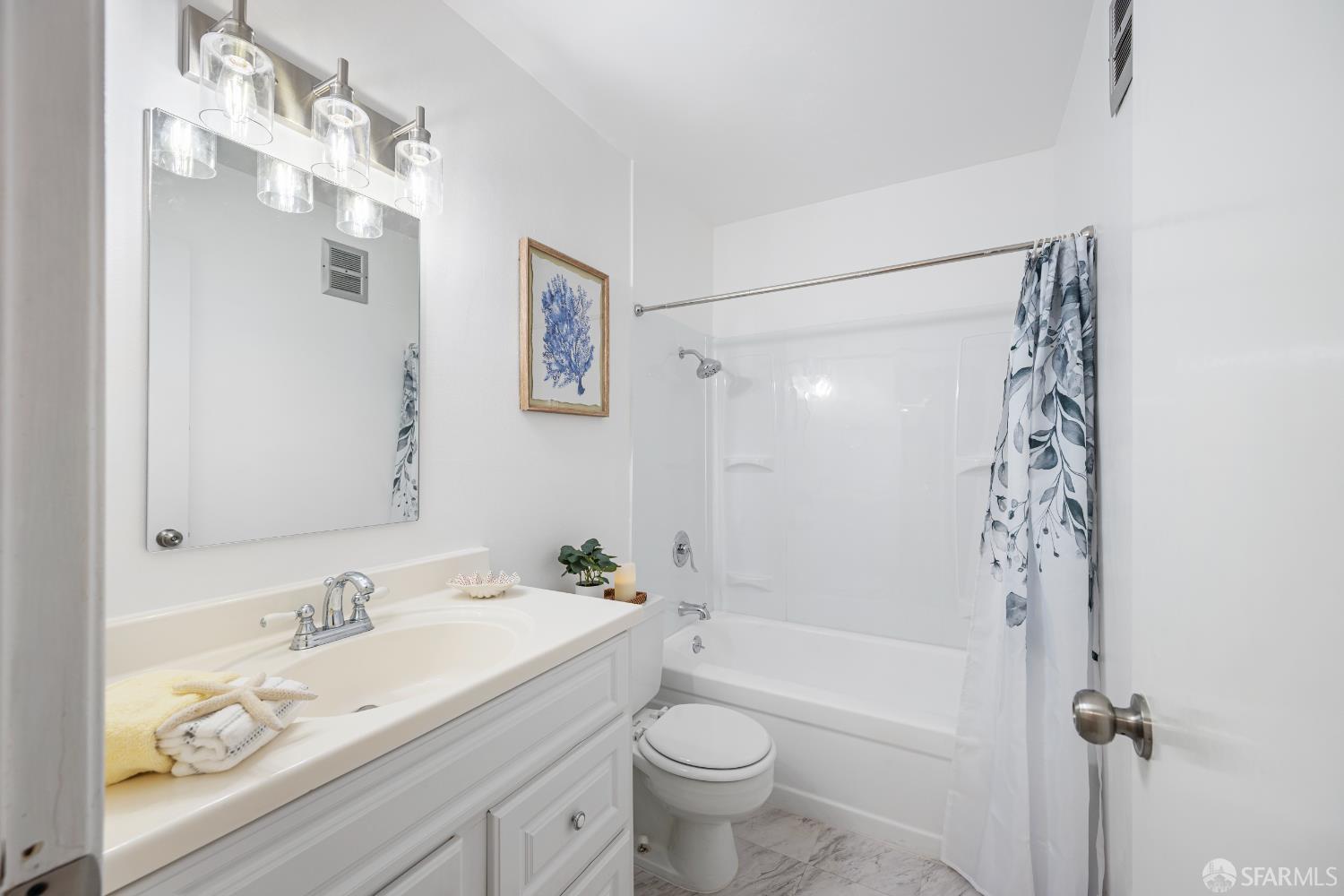 1327 Webster Street, Unit B210 Alameda, CA 94501 - Photo 19 of 55 a bathroom with a bathtub shower sink vanity and toilet