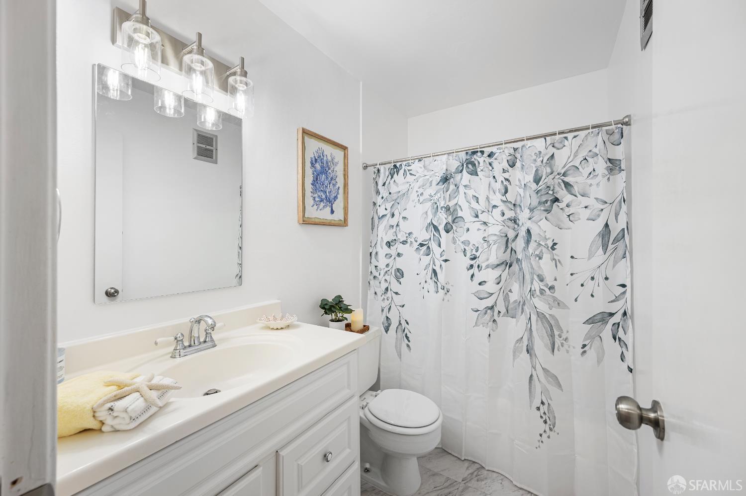 1327 Webster Street, Unit B210 Alameda, CA 94501 - Photo 20 of 55 a bathroom with a granite countertop sink a toilet and a mirror