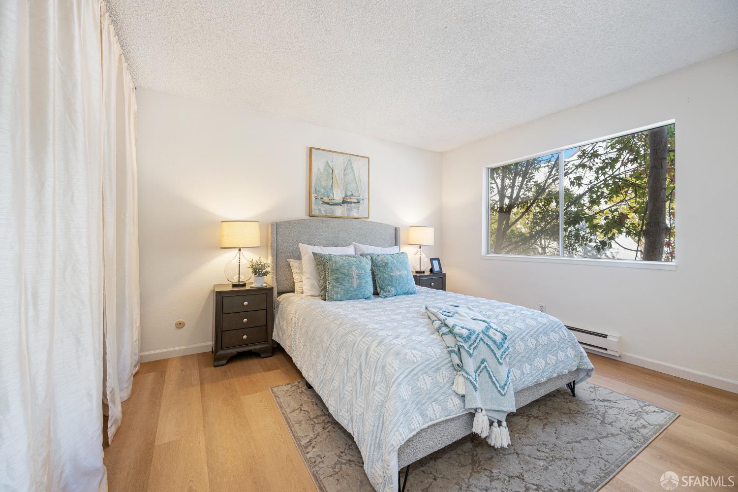 1327 Webster Street, Unit B210 Alameda, CA 94501 - Photo 21 of 55 a bedroom with a bed and a painting on the wall