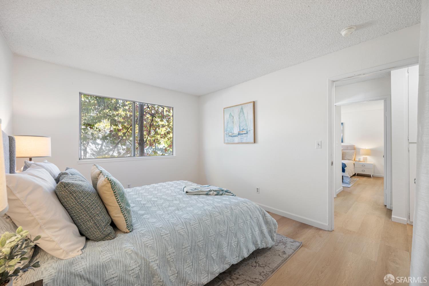 1327 Webster Street, Unit B210 Alameda, CA 94501 - Photo 23 of 55 a bedroom with a bed and a painting on the wall