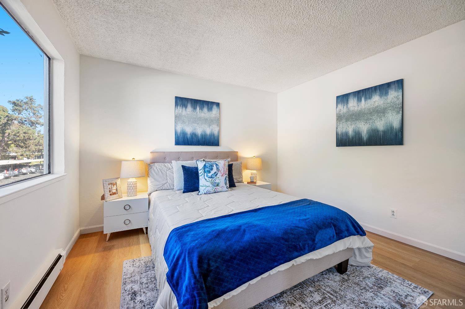 1327 Webster Street, Unit B210 Alameda, CA 94501 - Photo 25 of 55 a bedroom with a bed and a painting on the wall
