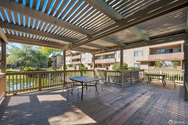 a view of a chairs and table in the roof deck