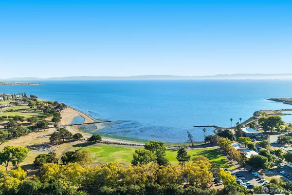 an aerial view of residential building and lake