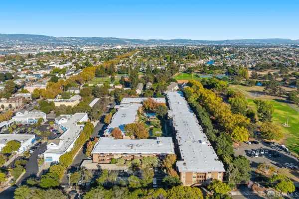 an aerial view of a residential apartment building with yard