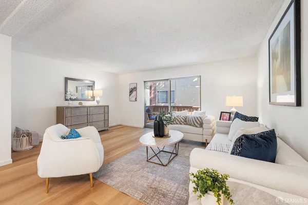 a living room with furniture and wooden floor