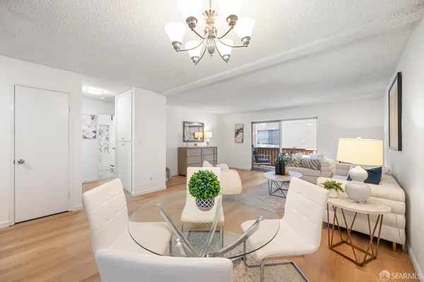 a living room with furniture and a chandelier