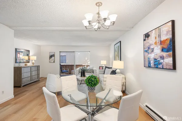 a view of a dining room with furniture wooden floor and a chandelier