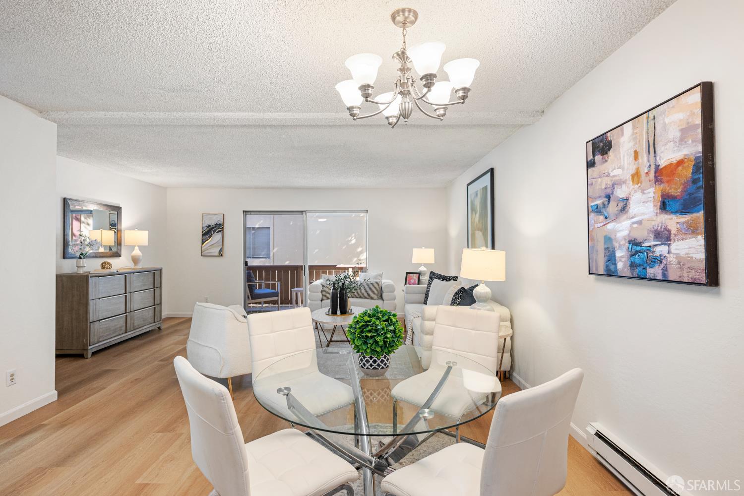 1327 Webster Street, Unit B210 Alameda, CA 94501 - Photo 9 of 55 a view of a dining room with furniture wooden floor and a chandelier