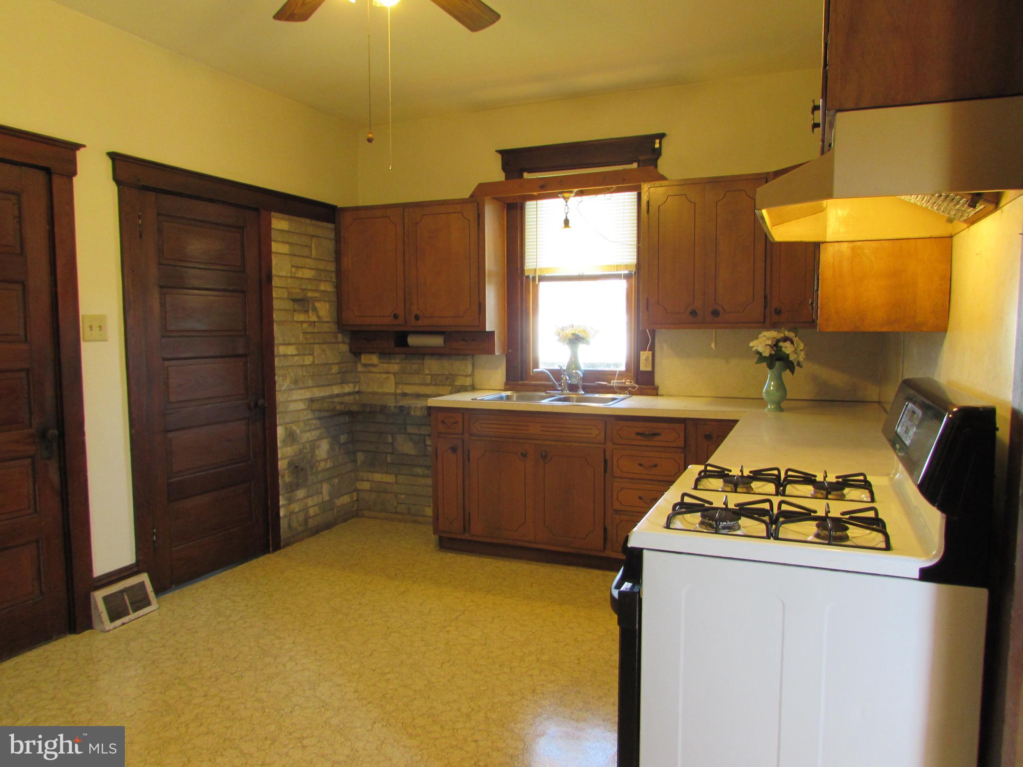 33 North Kinzer Road Kinzers, PA 17535 - Photo 6 of 15 a kitchen with a stove a sink a refrigerator and a dining table