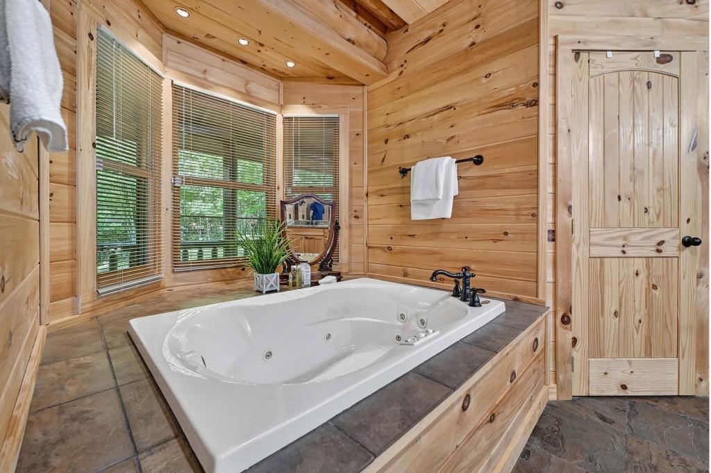 505 Old Salem Road Mineral Bluff, GA 30559 - Photo 21 of 88 a bathroom with a tub a sink and a large mirror
