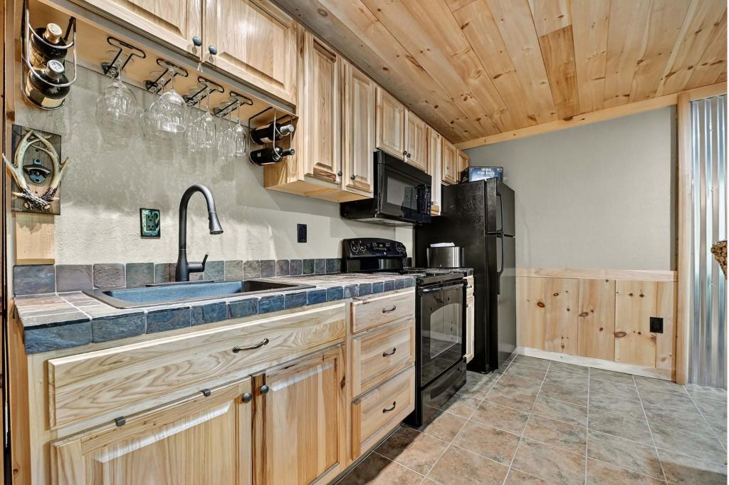 505 Old Salem Road Mineral Bluff, GA 30559 - Photo 40 of 88 a kitchen with stainless steel appliances granite countertop a sink a stove a refrigerator and cabinets