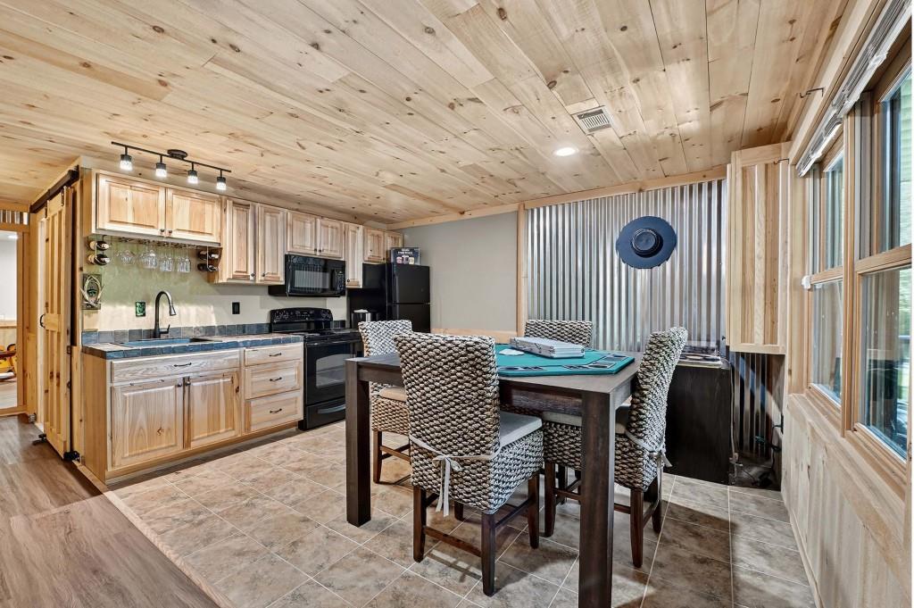 505 Old Salem Road Mineral Bluff, GA 30559 - Photo 42 of 88 a kitchen with kitchen island a dining table chairs cabinets and a sink