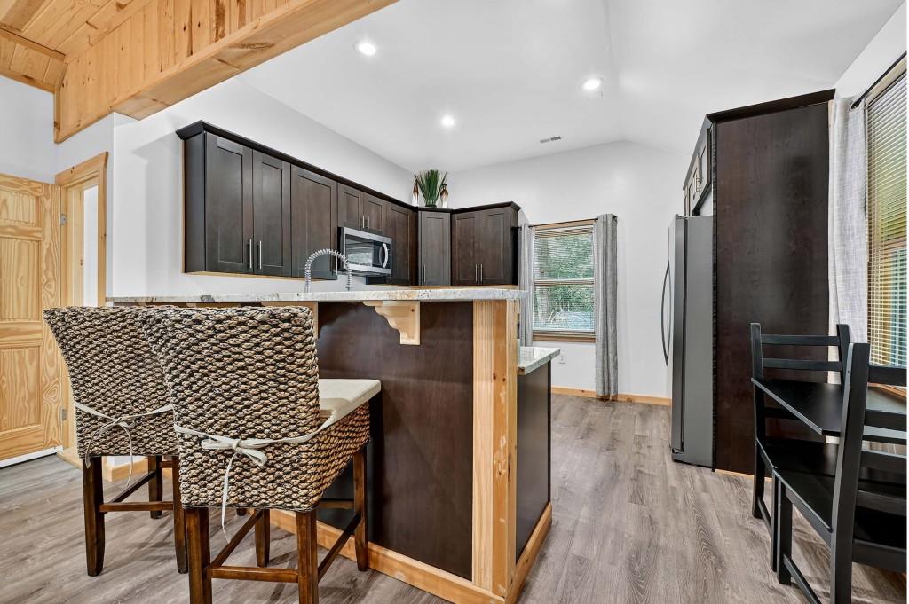 505 Old Salem Road Mineral Bluff, GA 30559 - Photo 58 of 88 a kitchen with a table chairs refrigerator and cabinets
