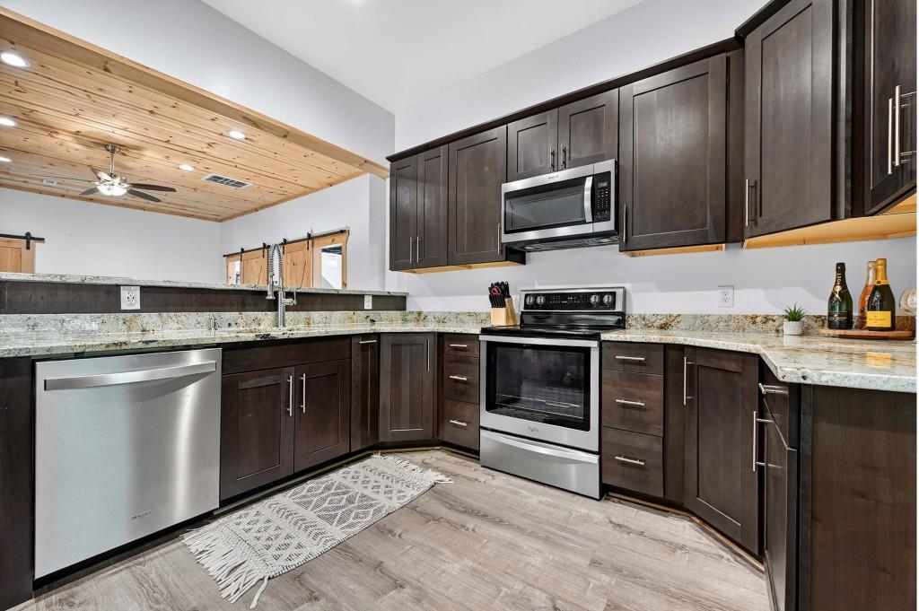 505 Old Salem Road Mineral Bluff, GA 30559 - Photo 60 of 88 a kitchen with stainless steel appliances granite countertop a stove microwave and sink
