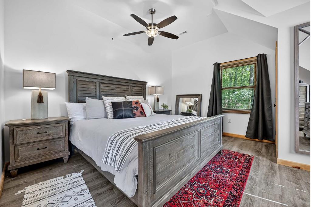 505 Old Salem Road Mineral Bluff, GA 30559 - Photo 63 of 88 a bedroom with a bed and a lamp on dresser