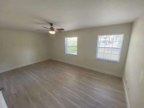 wooden floor in an empty room with a window
