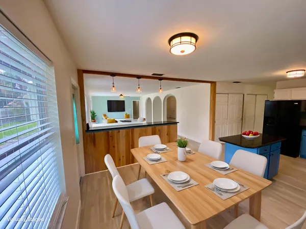 a dining room with furniture and wooden floor
