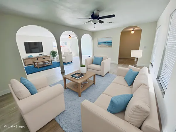 a living room with furniture and wooden floor