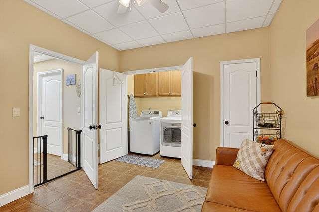 8179 Pineview Court Villa Rica, GA 30180 - Photo 30 of 41 a living room with furniture and a refrigerator