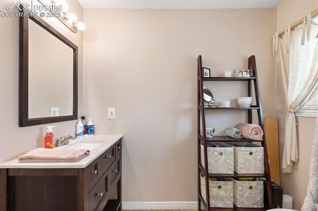 89 Security Boulevard Colorado Springs, CO 80911 - Photo 17 of 29 a bathroom with a sink and a mirror