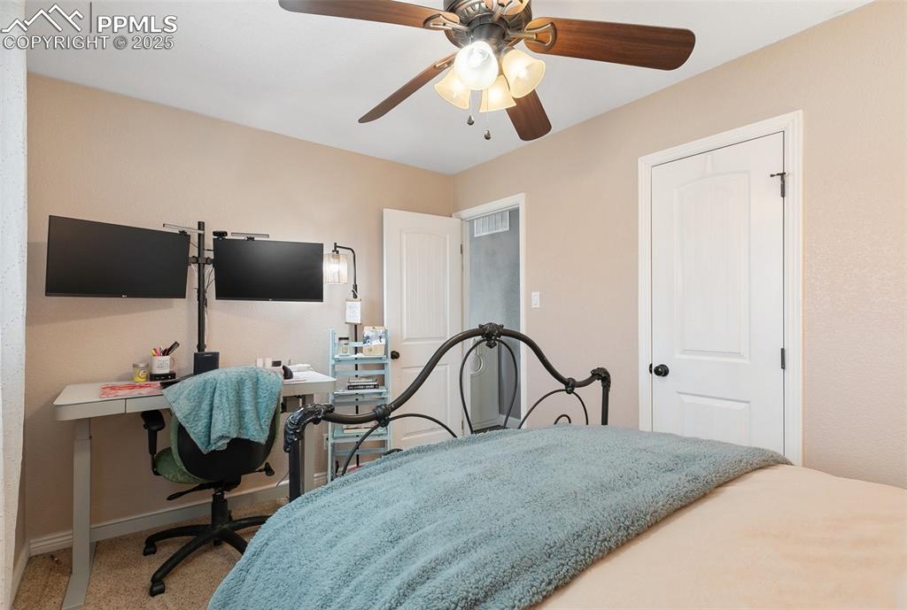 89 Security Boulevard Colorado Springs, CO 80911 - Photo 19 of 29 a bedroom with furniture and a flat screen tv