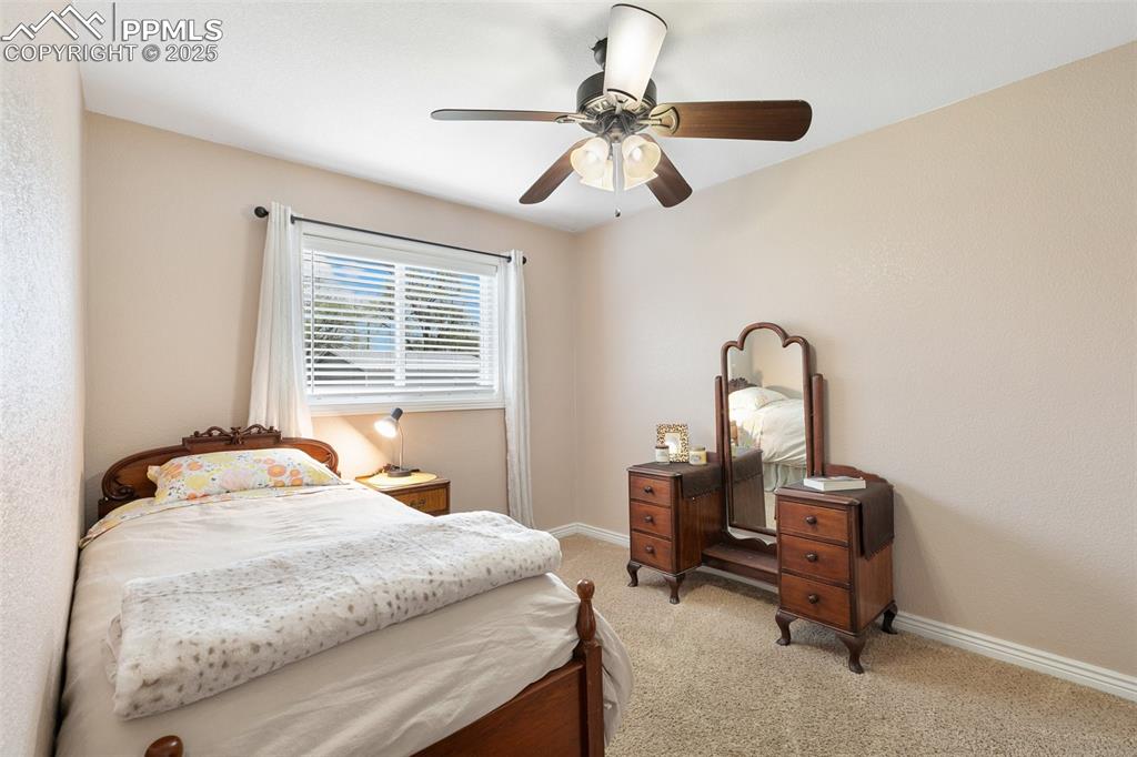 89 Security Boulevard Colorado Springs, CO 80911 - Photo 21 of 29 a bedroom with a bed and a table