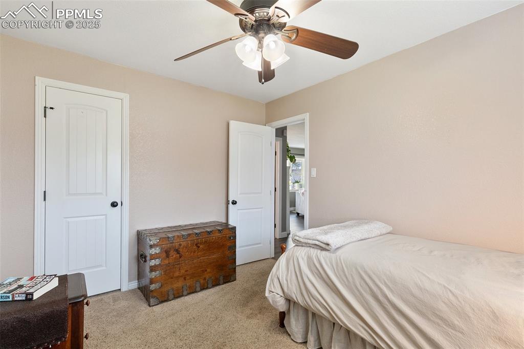 89 Security Boulevard Colorado Springs, CO 80911 - Photo 22 of 29 a bedroom with a bed and a chandelier