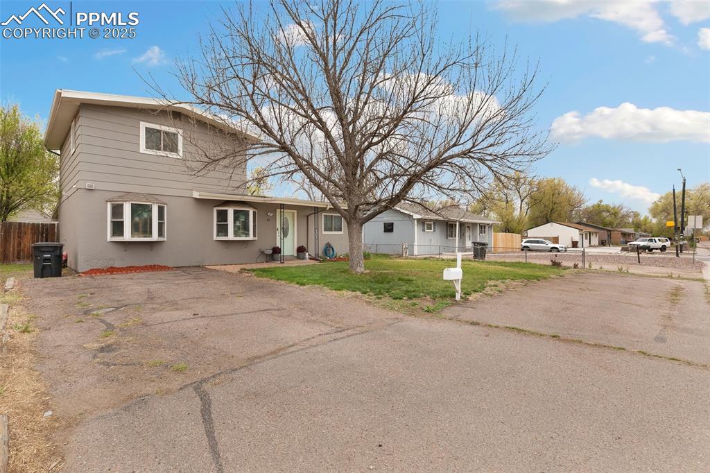 89 Security Boulevard Colorado Springs, CO 80911 - Photo 26 of 29 a front view of a house with a yard and garage