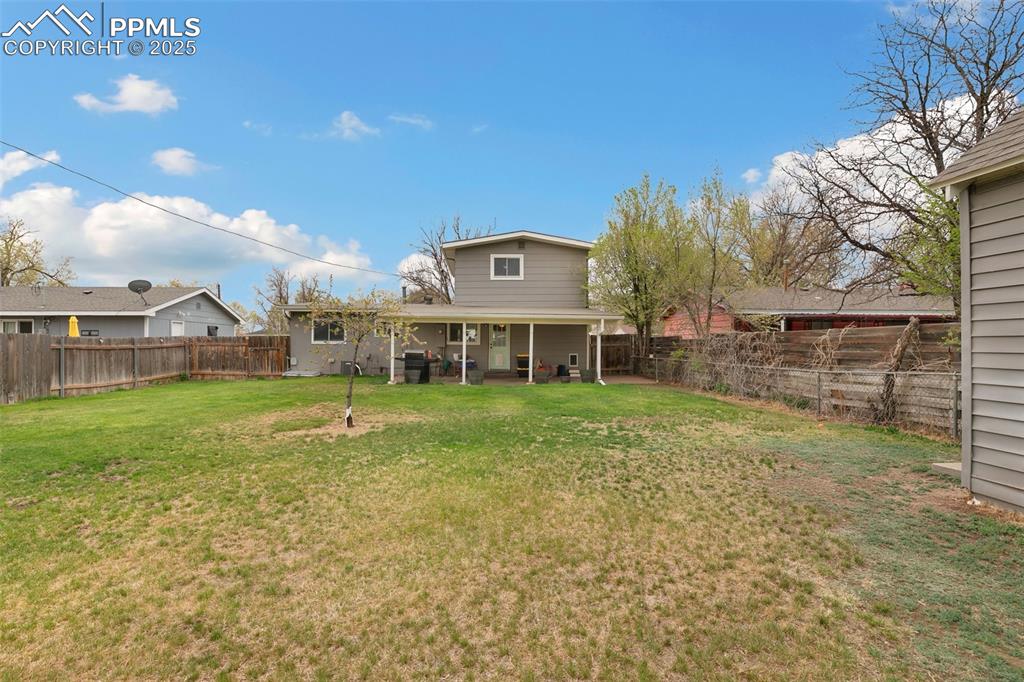 89 Security Boulevard Colorado Springs, CO 80911 - Photo 28 of 29 a view of a house with a big yard and a large tree