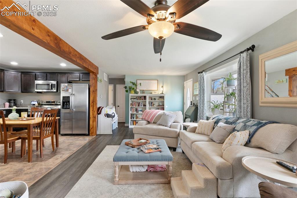 89 Security Boulevard Colorado Springs, CO 80911 - Photo 6 of 29 a living room with furniture and a large window with kitchen view
